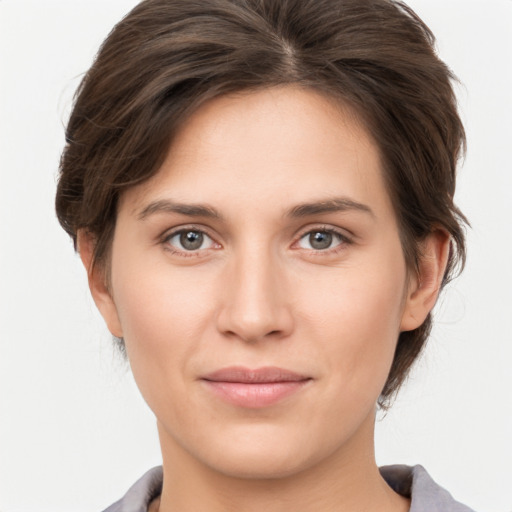 Joyful white young-adult female with short  brown hair and grey eyes