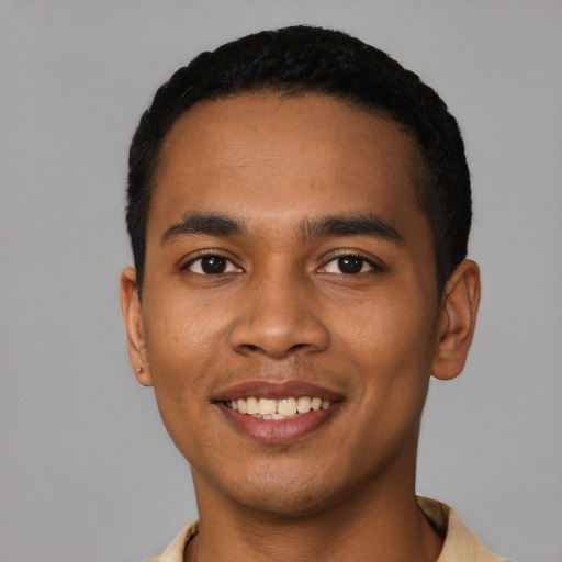 Joyful latino young-adult male with short  black hair and brown eyes