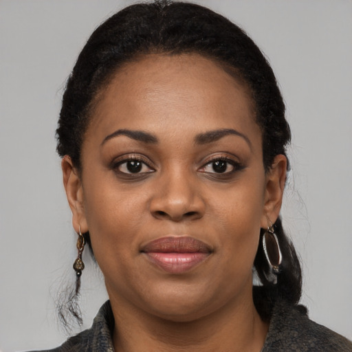 Joyful black young-adult female with medium  black hair and brown eyes