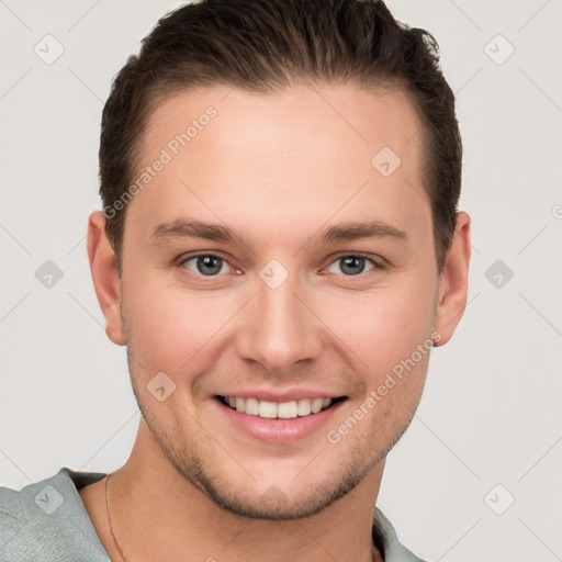 Joyful white young-adult male with short  brown hair and grey eyes