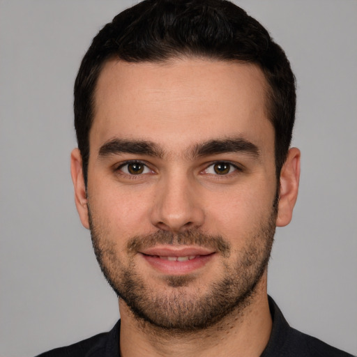 Joyful white young-adult male with short  brown hair and brown eyes