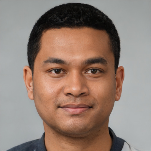 Joyful latino young-adult male with short  black hair and brown eyes