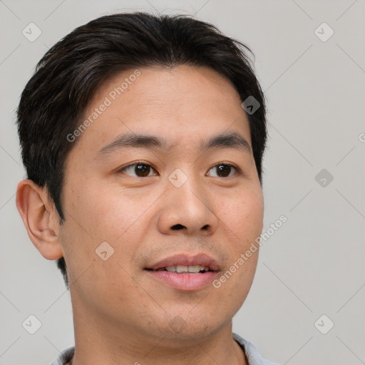 Joyful asian young-adult male with short  brown hair and brown eyes