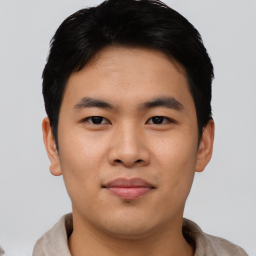 Joyful asian young-adult male with short  black hair and brown eyes