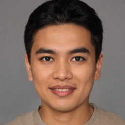 Joyful asian young-adult male with short  black hair and brown eyes