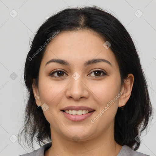 Joyful latino young-adult female with medium  brown hair and brown eyes