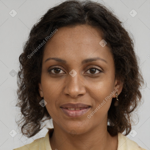 Joyful black young-adult female with long  brown hair and brown eyes