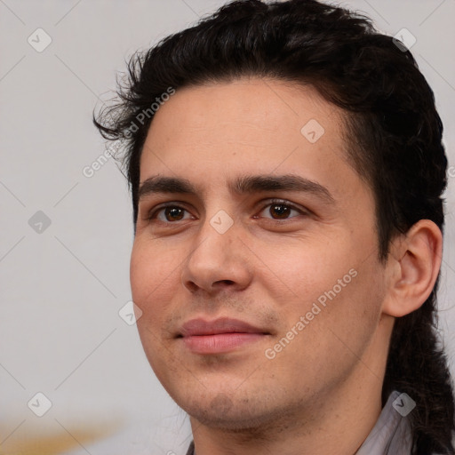 Joyful white young-adult male with short  black hair and brown eyes