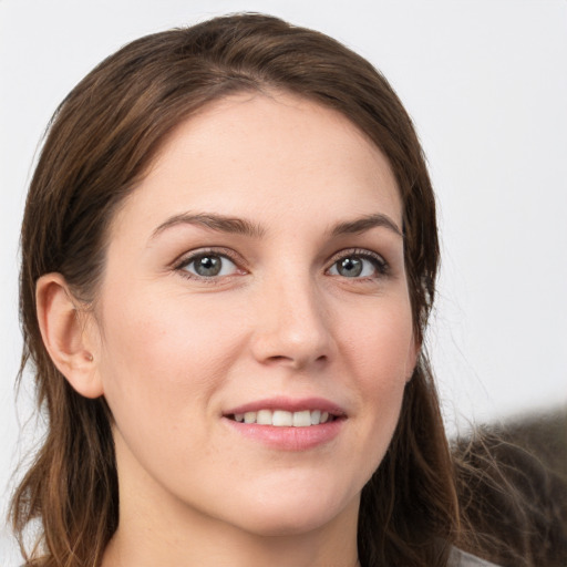 Joyful white young-adult female with long  brown hair and grey eyes