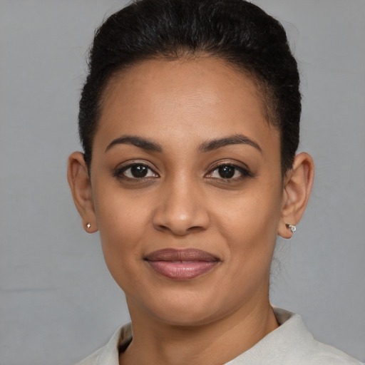 Joyful latino young-adult female with short  brown hair and brown eyes