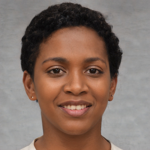 Joyful black young-adult female with short  black hair and brown eyes