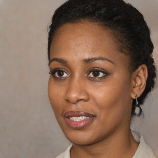 Joyful black young-adult female with medium  brown hair and brown eyes