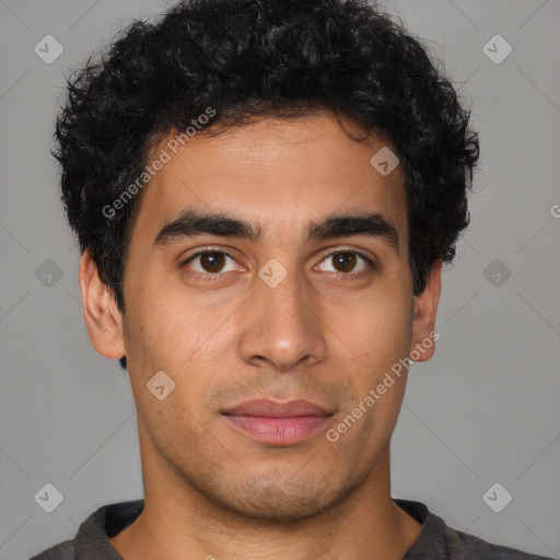 Joyful latino young-adult male with short  brown hair and brown eyes