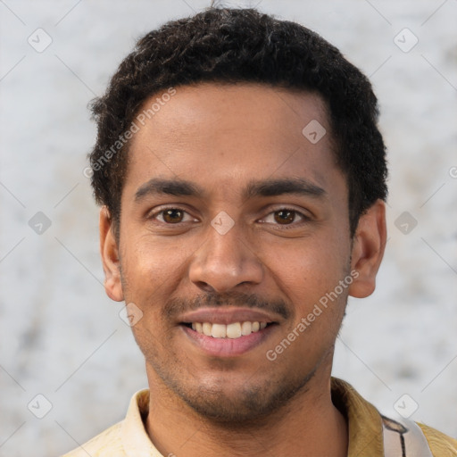 Joyful black young-adult male with short  brown hair and brown eyes