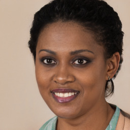 Joyful black young-adult female with short  black hair and brown eyes