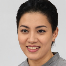 Joyful asian young-adult female with short  brown hair and brown eyes