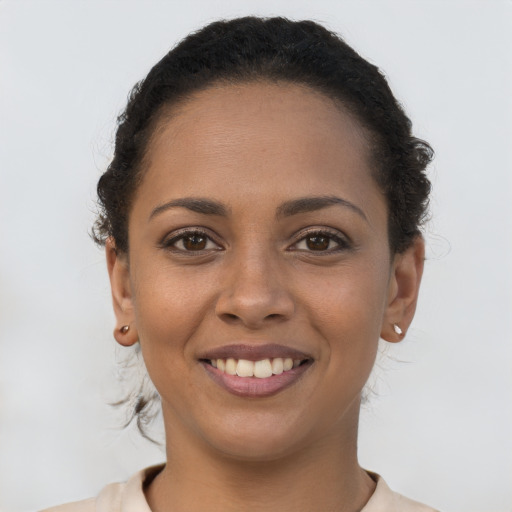 Joyful latino young-adult female with short  brown hair and brown eyes