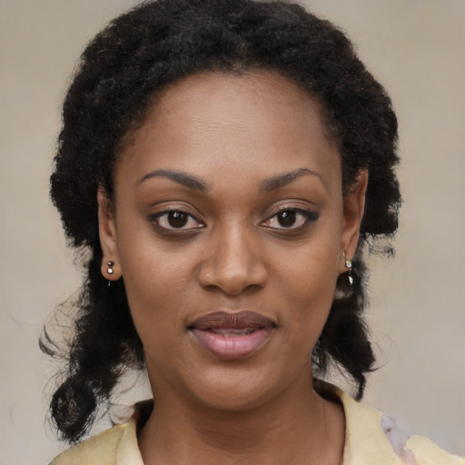 Joyful black young-adult female with medium  black hair and brown eyes
