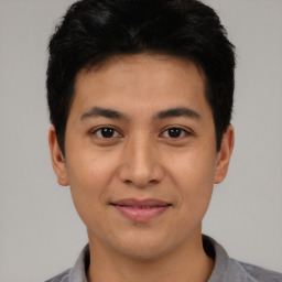 Joyful asian young-adult male with short  black hair and brown eyes