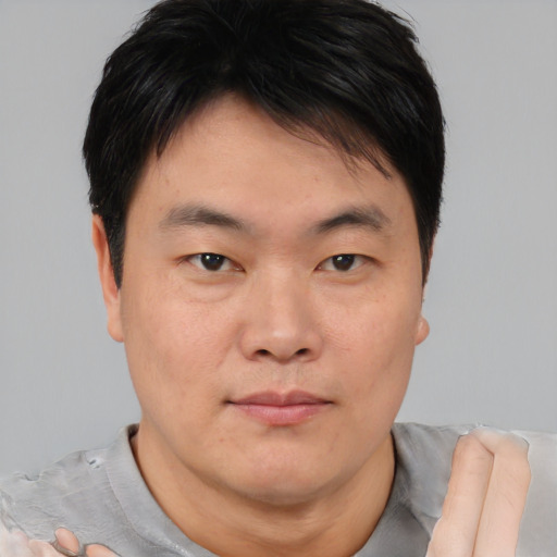 Neutral asian young-adult male with short  brown hair and brown eyes