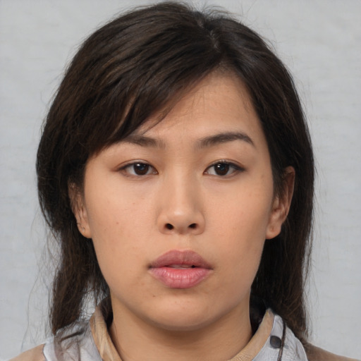 Neutral asian young-adult female with medium  brown hair and brown eyes