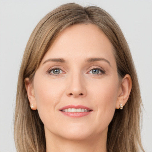 Joyful white young-adult female with long  brown hair and grey eyes