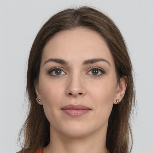 Joyful white young-adult female with long  brown hair and grey eyes