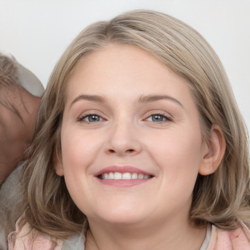 Joyful white young-adult female with medium  brown hair and blue eyes