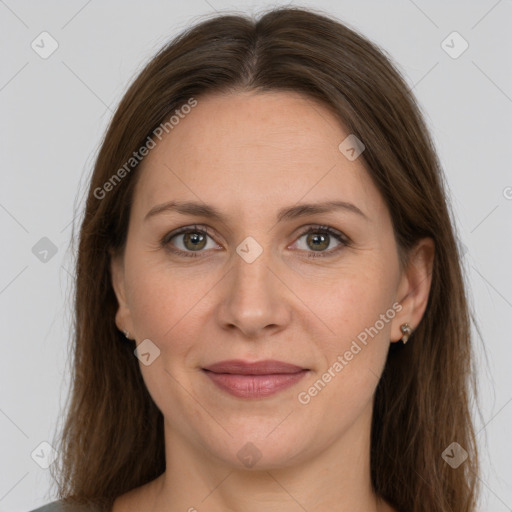 Joyful white adult female with long  brown hair and grey eyes