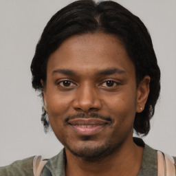 Joyful black young-adult male with short  black hair and brown eyes