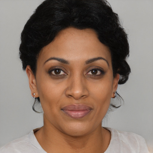 Joyful latino young-adult female with short  black hair and brown eyes
