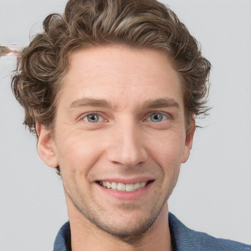 Joyful white adult male with short  brown hair and blue eyes