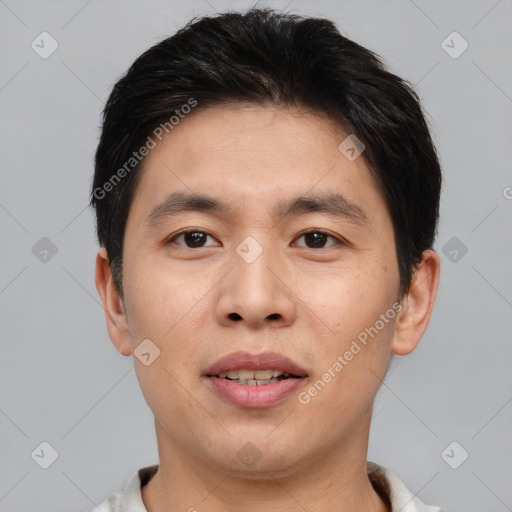 Joyful asian young-adult male with short  brown hair and brown eyes