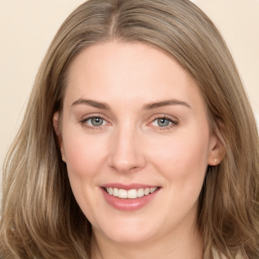 Joyful white young-adult female with long  brown hair and brown eyes