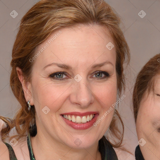 Joyful white adult female with medium  brown hair and blue eyes