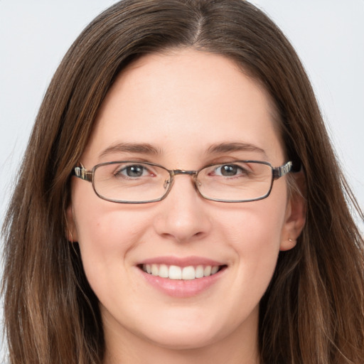 Joyful white young-adult female with long  brown hair and grey eyes