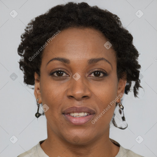 Joyful black adult female with short  brown hair and brown eyes