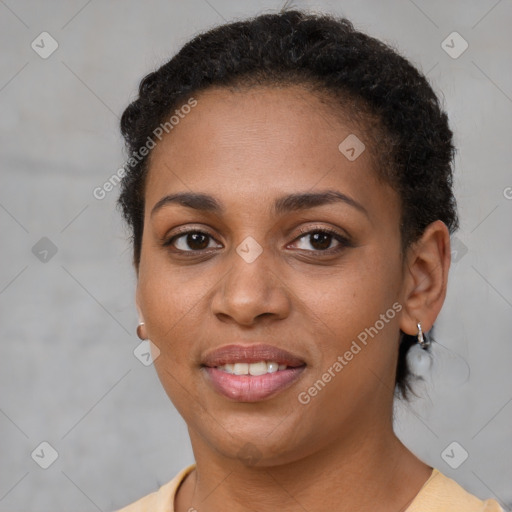 Joyful black young-adult female with short  brown hair and brown eyes