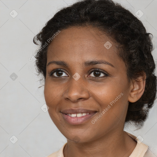 Joyful black young-adult female with short  brown hair and brown eyes