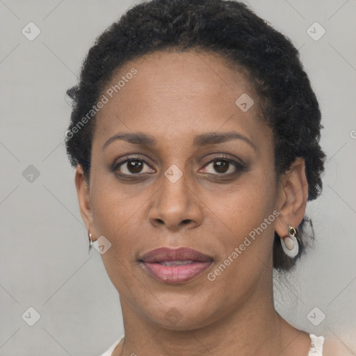 Joyful black adult female with short  brown hair and brown eyes