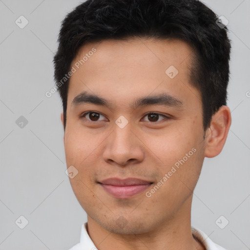 Joyful asian young-adult male with short  brown hair and brown eyes