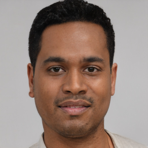 Joyful latino young-adult male with short  black hair and brown eyes