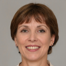 Joyful white adult female with medium  brown hair and grey eyes