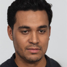 Neutral latino young-adult male with short  black hair and brown eyes