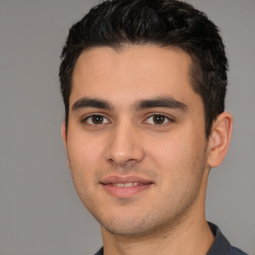Joyful white young-adult male with short  black hair and brown eyes