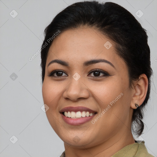 Joyful latino young-adult female with medium  brown hair and brown eyes