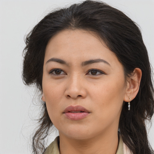 Joyful asian young-adult female with long  brown hair and brown eyes