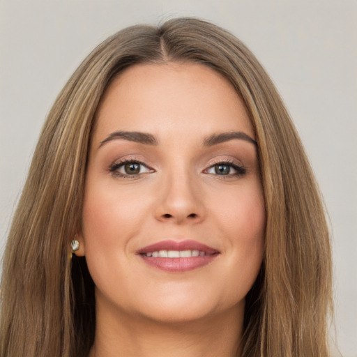 Joyful white young-adult female with long  brown hair and brown eyes