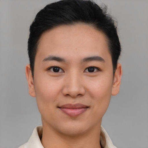 Joyful asian young-adult male with short  brown hair and brown eyes