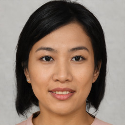 Joyful asian young-adult female with medium  black hair and brown eyes